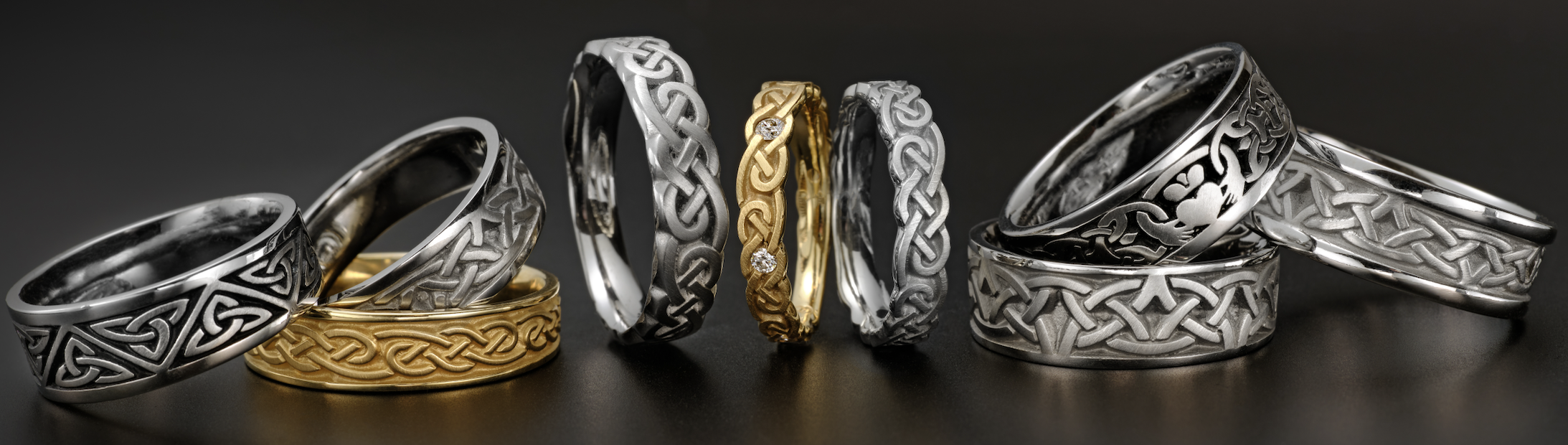 A display of Celtic wedding rings featuring intricate, symbolic, and ancient Celtic knotwork patterns in precious metals including gold, silver, platinum, and palladium.